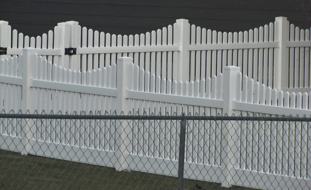 White vinyl fence with decorative picket profile